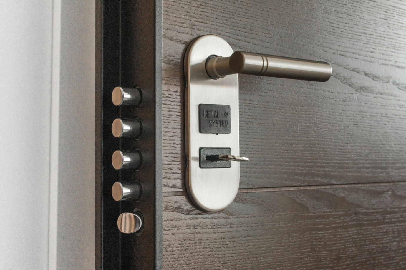 Close-up of a deadlock with a key inserted in the keyhole