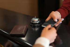 A hotel employee handing a hotel keycard to a guest